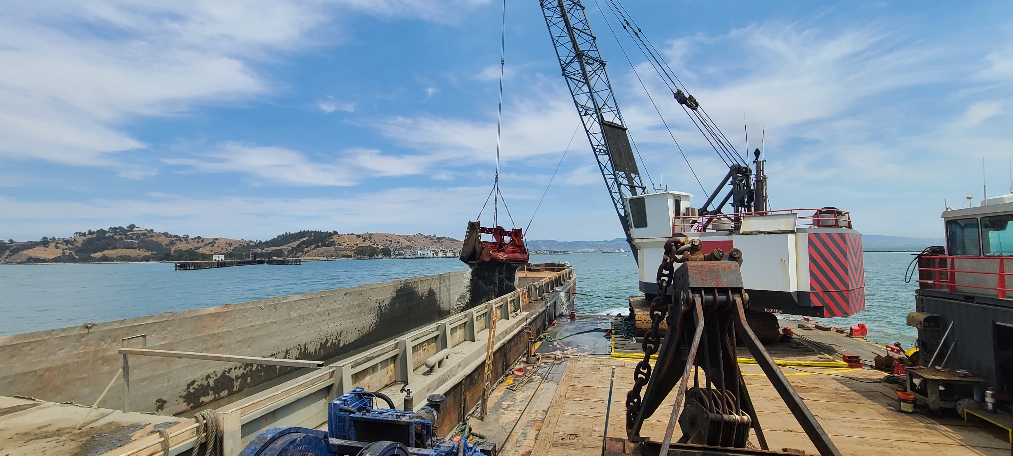 dredge on water with blue sky